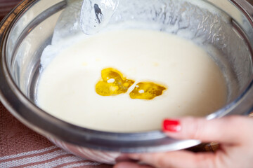 Two yellow spots of oil in the batter