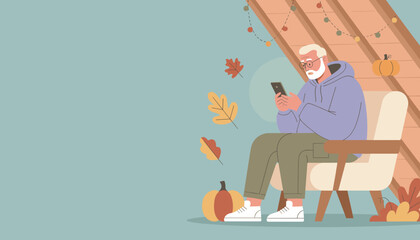 Grandpa using phone in a cozy attic chair surrounded by fall leaves and pumpkins Digital lifestyle