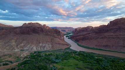 Aerial drone view of Colorado River red rock canyons at sunset in Moab, Utah