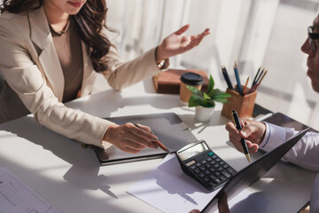 Businesswoman discussing financial strategy with client, analyzing data