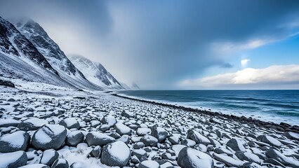 Snowy rocky beach with mountain and sea under cloudy sky landscape