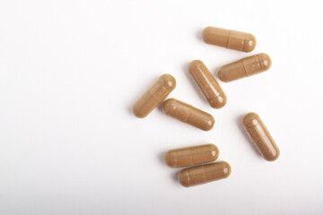 Vitamin capsules isolated on white background, top view. Health supplement