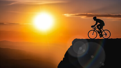 Silhouette male cyclist riding bicycle mountain top cliff sunset sky background outdoor sport activity healthy lifestyle adventure travel freedom concept extreme