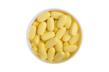 Vitamin pills in a medicine bottle cap isolated on a white background, top view. Health supplements