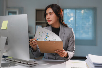 Businesswoman analyzing corporate financial data at office desk