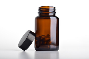 Opened vitamin pill bottle isolated on a white background. Medical treatment pills.