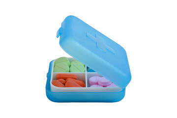 Various pills and capsules in a medicine box isolated on a white background. Concept of medicines and health supplements.