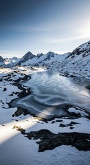 Frozen alpine lake nestled amongst snow-capped mountains, showcasing intricate ice patterns illuminated by the morning sun.
