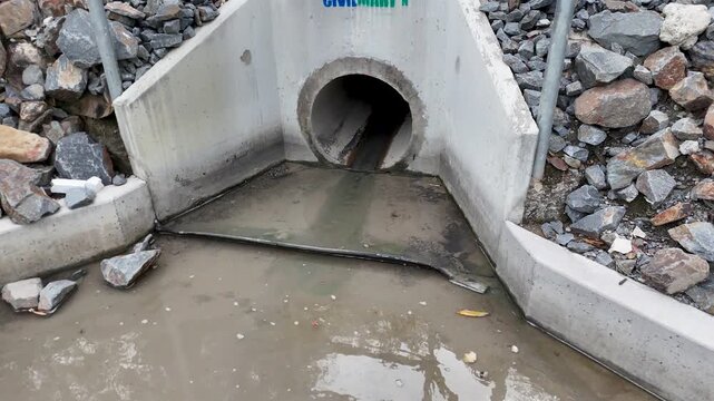 Stormwater Flow Through Concrete Drainage Culvert Close-Up