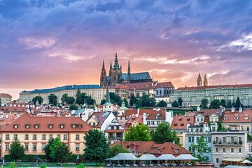 Fototapeta premium Experience the stunning beauty of Prague, Czech Republic. Explore St. Vitus Cathedral, historic architecture, and vibrant sunsets in this magical city. Ideal for travel enthusiasts.