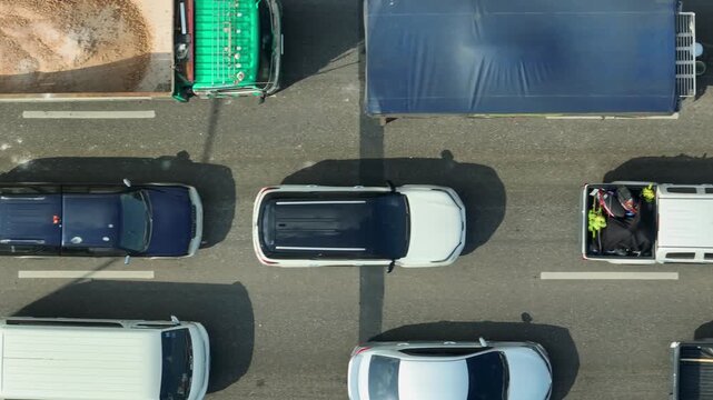 From above, dense multi-lane traffic illustrates commuting delays, limited road capacity, urban mobility issues, infrastructure stress, and the importance of improved transportation planning.
