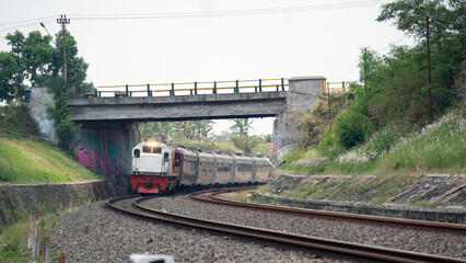 A fast-moving train glides smoothly along the railway tracks, showcasing power, motion, and precision in transportation © AntxPhotoStock