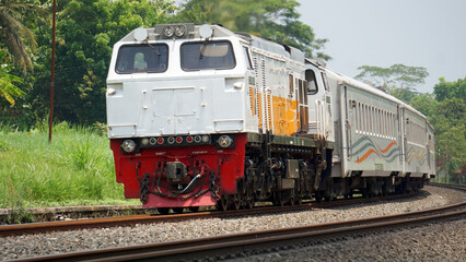 A fast-moving train glides smoothly along the railway tracks, showcasing power, motion, and precision in transportation © AntxPhotoStock