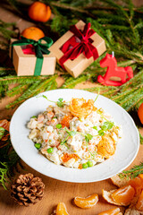 Colorful salad features shrimp, greens, and vibrant accents among holiday gifts and natural decor