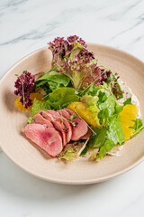 A vibrant salad of succulent duck, fresh greens, and juicy citrus