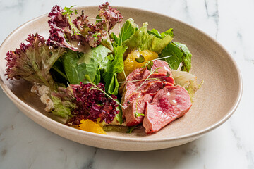 A colorful blend of greens, tender meat, and citrus makes for a delightful culinary experience