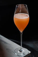 A vibrant cocktail in a tall glass glimmers as bubbles rise, creating a lively atmosphere