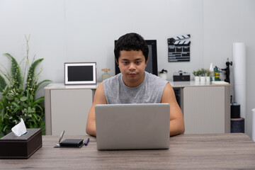 Man freelance working at home on laptop computer.