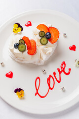 A beautiful heart-shaped treat adorned with fruits, cream, and artistic designs, celebrating love