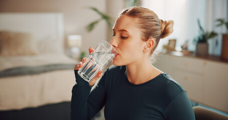 Fitness, woman and drink water in home for health, wellness or nutrition on break with glass. Exercise recovery, hydration or thirsty person with liquid in bedroom for detox, electrolytes or minerals