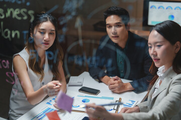 Business team collaborating on new project strategy in office