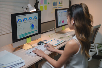 Businesswoman analyzing consumer demographics data on computer screen