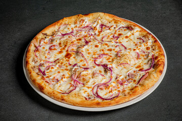 Delicious pizza topped with melted cheese and vibrant red onions, ready to be enjoyed