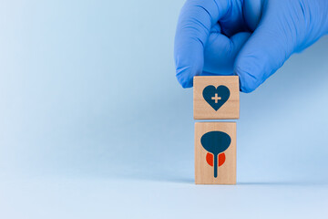 The doctor arranges wooden cubes with a prostate icon and a heart. PSA test awareness concept. Early detection of prostate cancer. Men's health.
