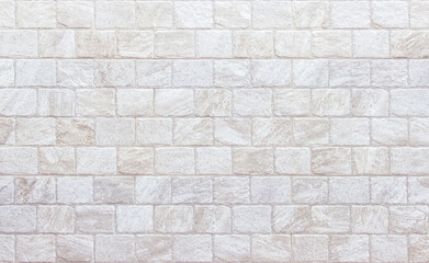 Naklejka premium Detail of modern cream brick wall background photo. White light brick wall texture background for stone tile block painted in beige light color wallpaper modern interior and exterior backdrop design.