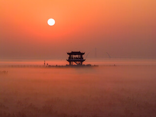 Sunrise over wetlands, morning mist, Chinese-style pavilion