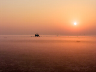 Sunrise over wetlands, morning mist, Chinese-style pavilion