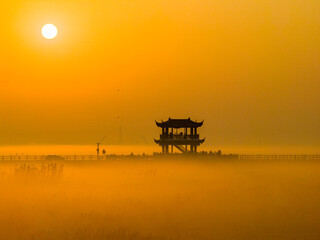 Sunrise over wetlands, morning mist, Chinese-style pavilion
