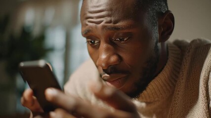 Family expense tracking app helps young man review budget and receipt photos smartphone with focused calm expression while managing finance
