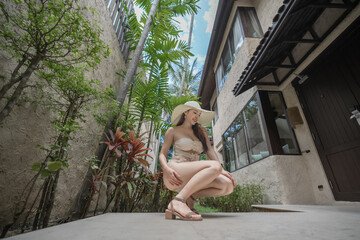 Woman in sexy bikini with tropical garden background.