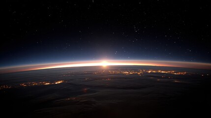 Dramatic Sunrise Above Earth Horizon Showing City Lights and Starry Sky