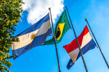 Brazilian Argentine and Paraguayan flag flags blue sky in Brazil.