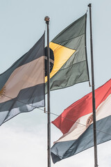 Brazilian Argentine and Paraguayan flag flags blue sky in Brazil.