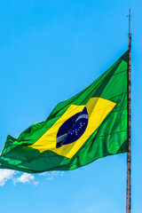 Brazilian flag waving in the wind with blue sky Brazil.