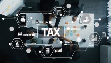 A business team collaborates on tax strategies and financial planning, surrounded by digital icons representing various financial concepts in a modern office setup. Amity