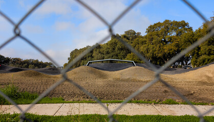 Skate Park Under Construction Seen Through Chain Link Fence