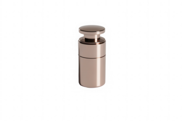 Small metal object with knob on top against a black background