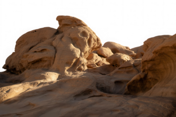 Dramatic desert rock formations illuminated by golden hour sunlight against black sky