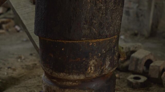 man's foot followed by cow footstep to make mustard oil in "Ghani" 