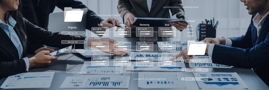 A group of professionals engage in a collaborative meeting, analyzing business reports and data charts to drive strategic decisions and enhance productivity in the modern workplace. Trope - Powered by Adobe