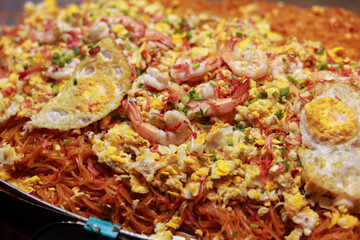 Delicious close up of Asian stir fried noodle with shrimp and egg. Savory Thai street food meal popular, appetizing dish for lunch, tasty and fresh culinary experience