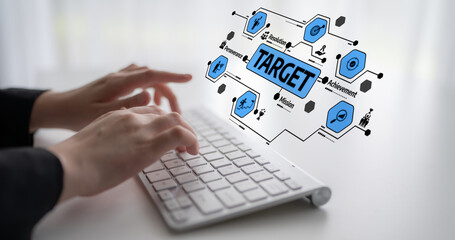 Close-up of hands typing on a keyboard, featuring an overlay of a target achievement concept. Perfect for themes of productivity, success, and goal-setting in a modern office. Tessel