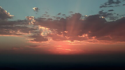 Dramatic Sunset Sky With Golden Light Rays Shining Through Clouds Over Distant Haze