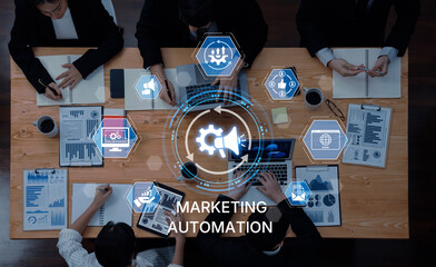A diverse team collaborates on marketing automation strategies, utilizing data analytics and visual tools to enhance business growth and communication in a modern office setting. Trope