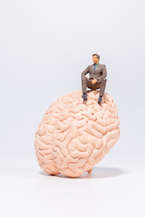 Tiny Executive Figure on Brain Symbol
