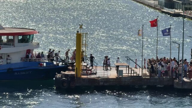 Passengers disembarking from Bosphorus ferry at Ortakoy waterfront pier